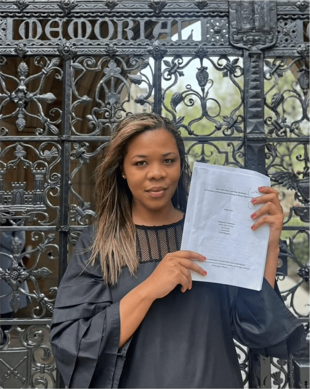 Allegra Ayida holding her thesis